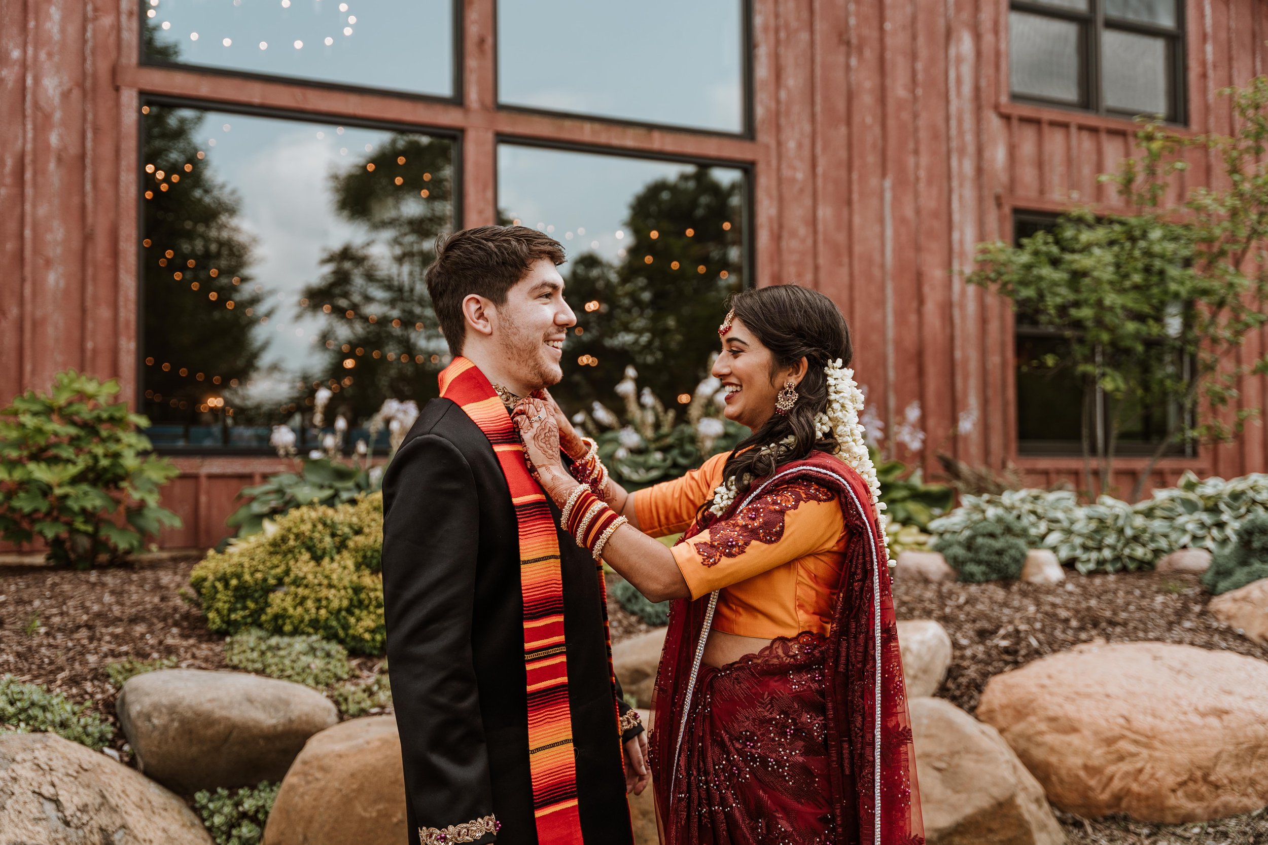 Bride helps groom outside of their Hornbakers Wedding
