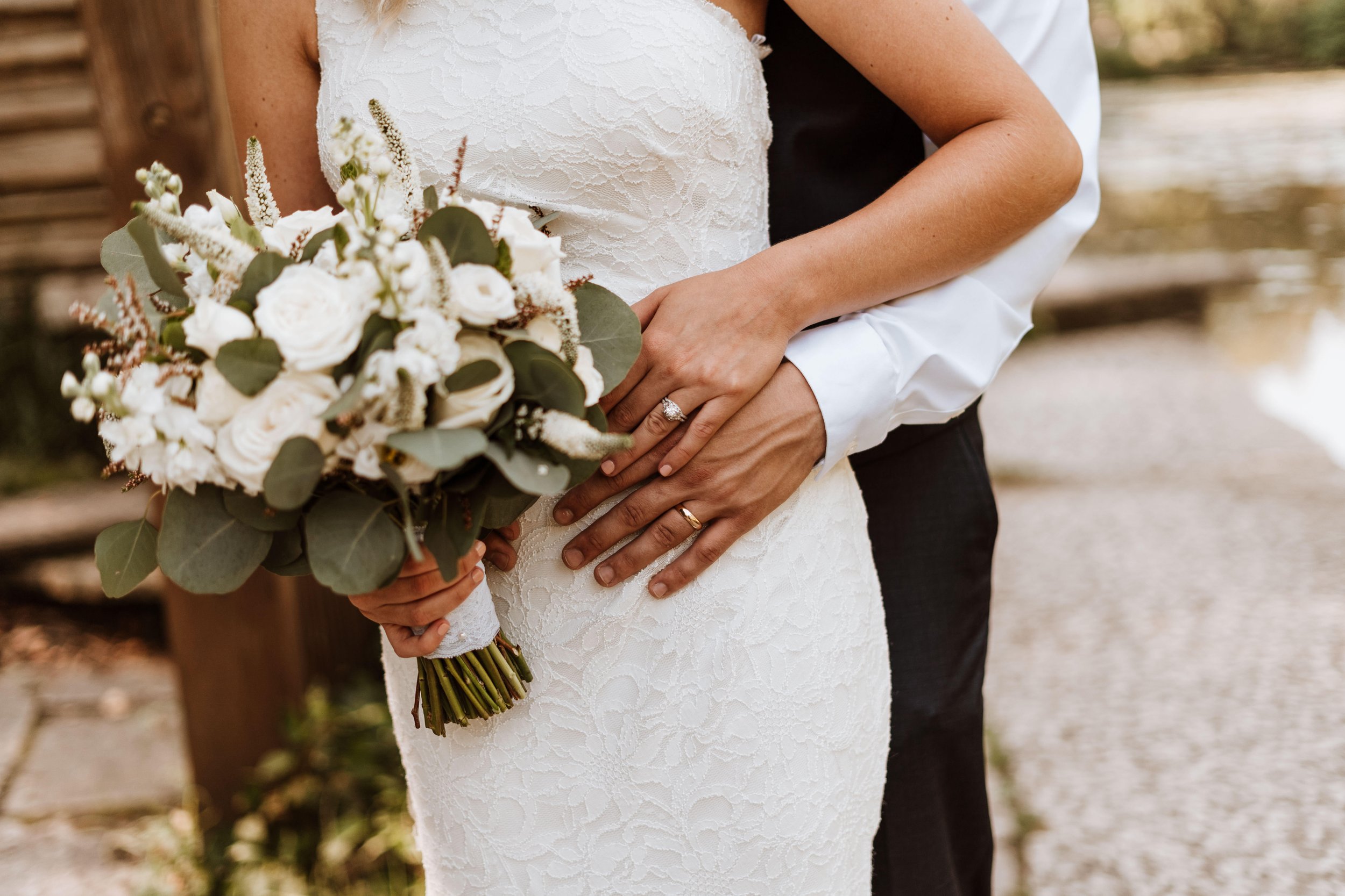 Bride and groom taking photos with the bridal bouquet