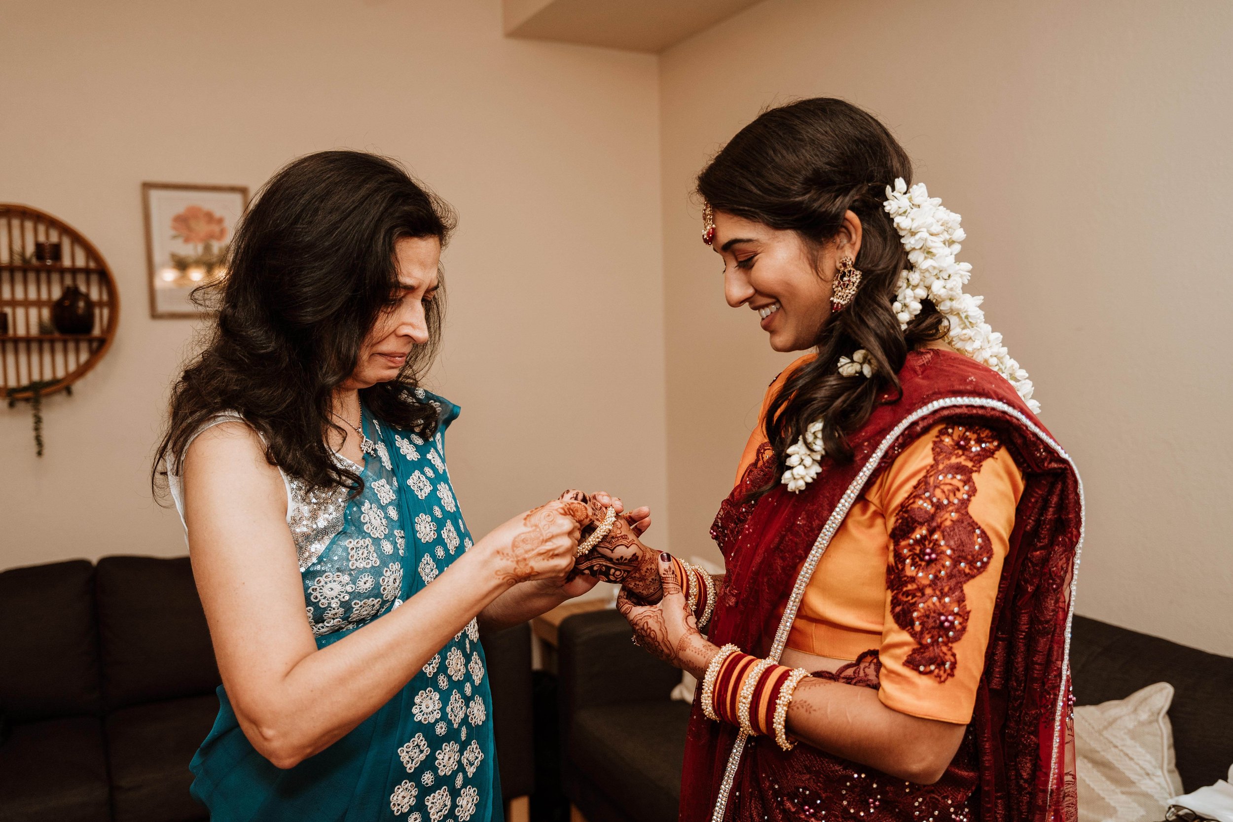 Family members help the bride put on her finishing touches at her large Illinois wedding