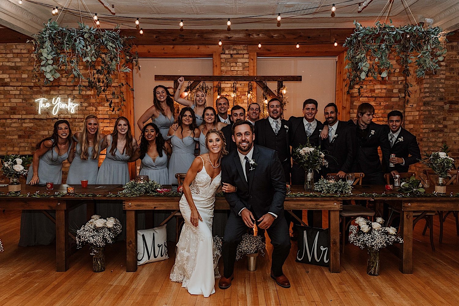 Wedding party group photo at the head table