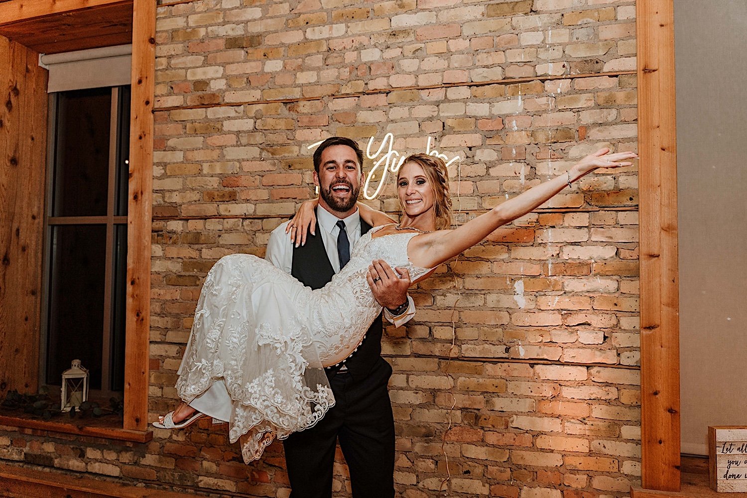 Bride and groom celebrate at the end of their wedding day at Highland Lofts in Elgin