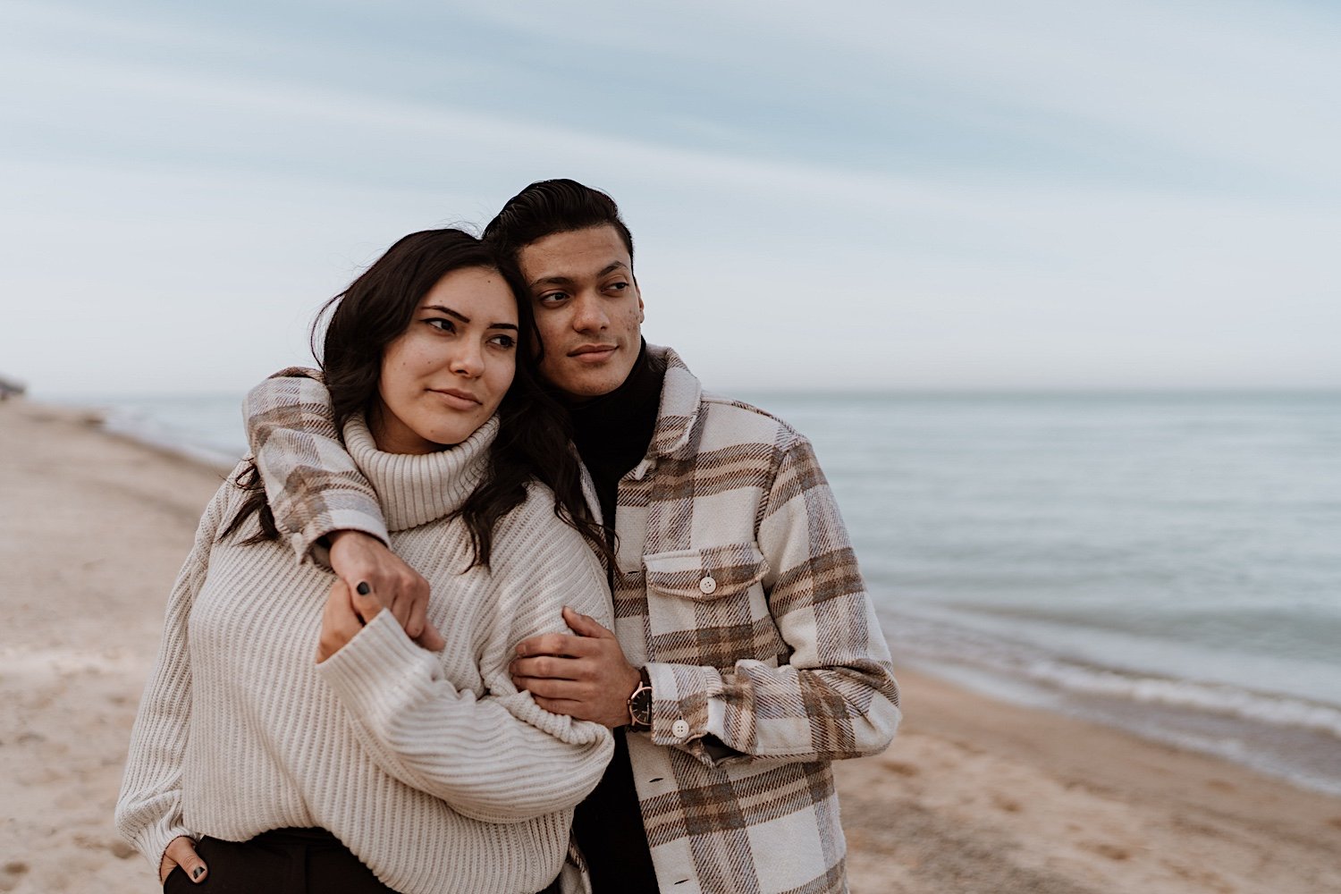 Couple poses at the beach for anniversary session at Indiana Dunes