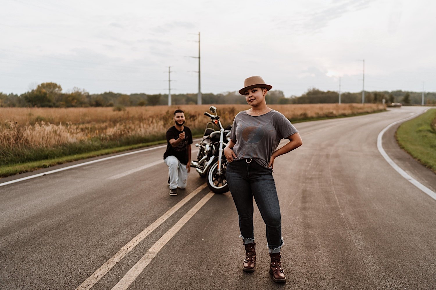 Man gets down on one knee in road behind girlfriend for surprise proposal