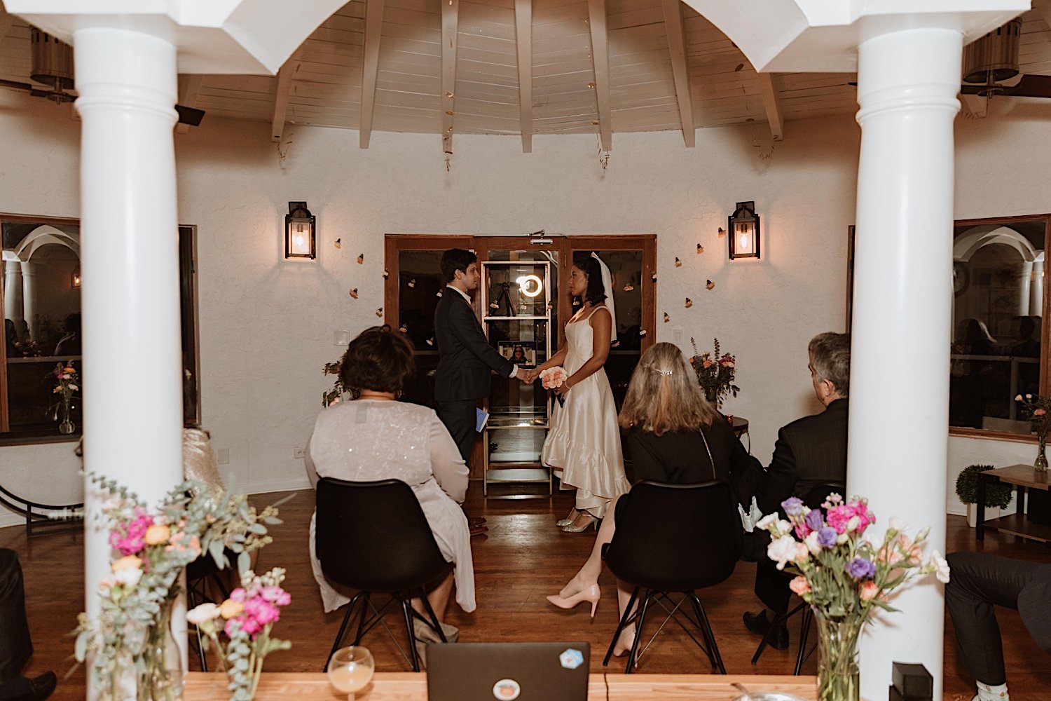 Bride and groom hold hands at intimate Indiana wedding ceremony