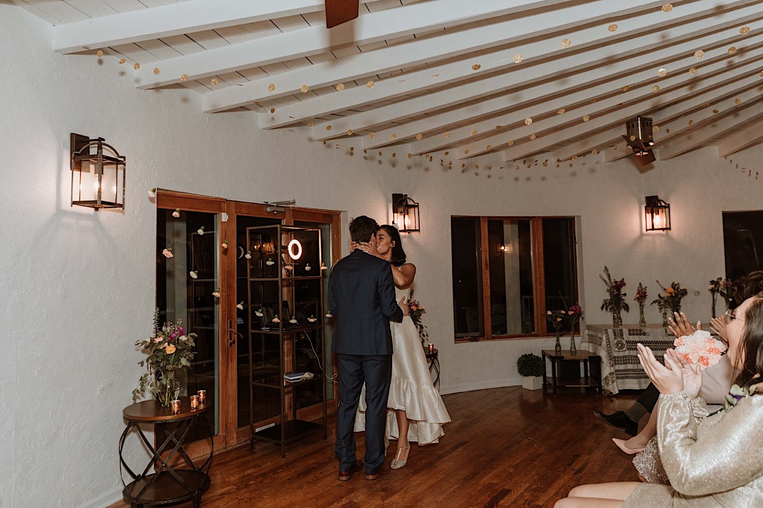 Bride and groom share first kiss at Intimate Indiana wedding reception