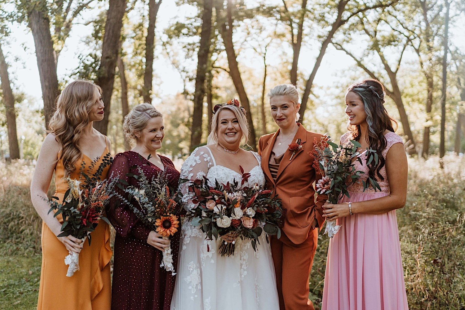 Bride and bridesmaids pose before their Lake Ellyn Boathouse wedding