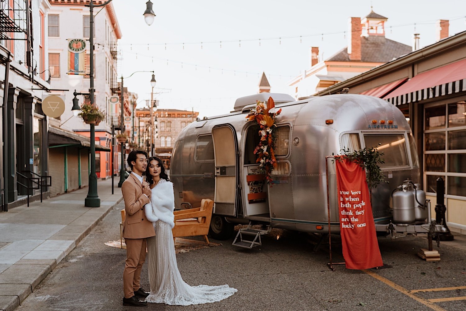 Couple pose in front of RV on Cincinnati street during elopement