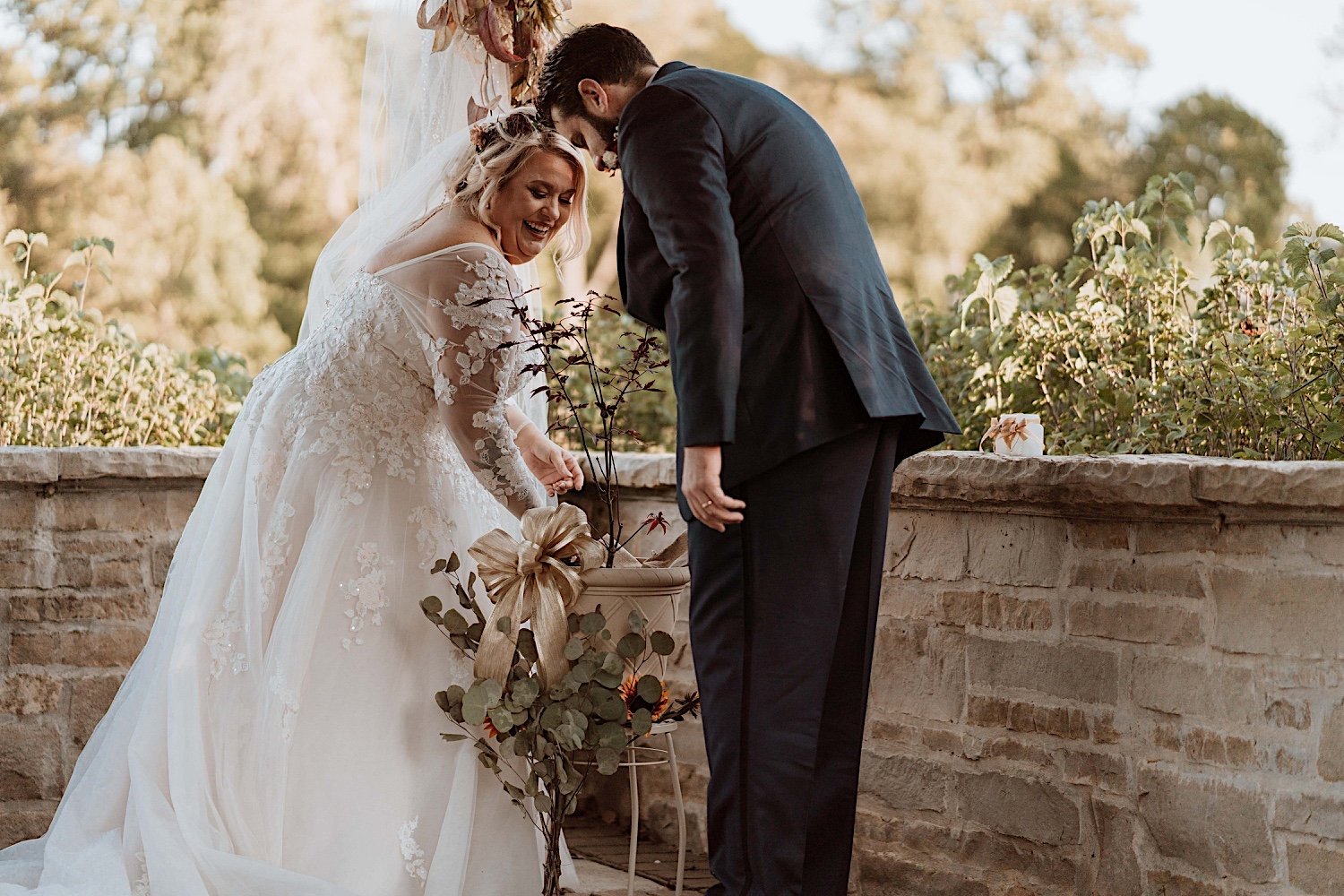 Bride and groom plant a small tree as part of their Lake Ellyn Boathouse wedding ceremony
