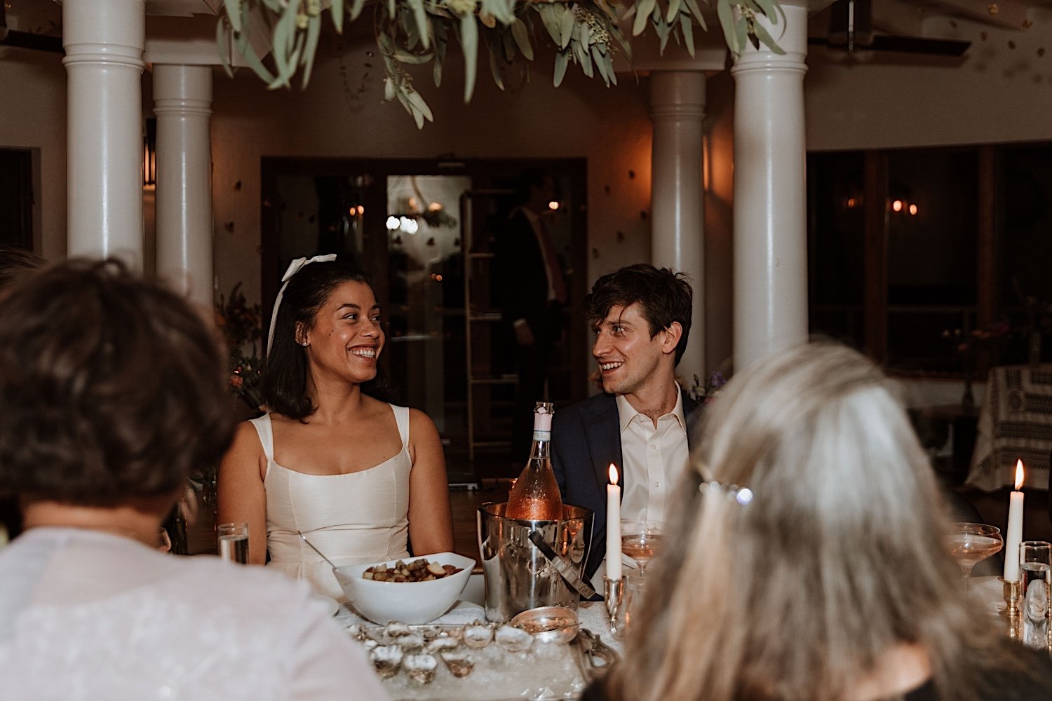 Bride and groom seated at reception table for intimate Indiana wedding