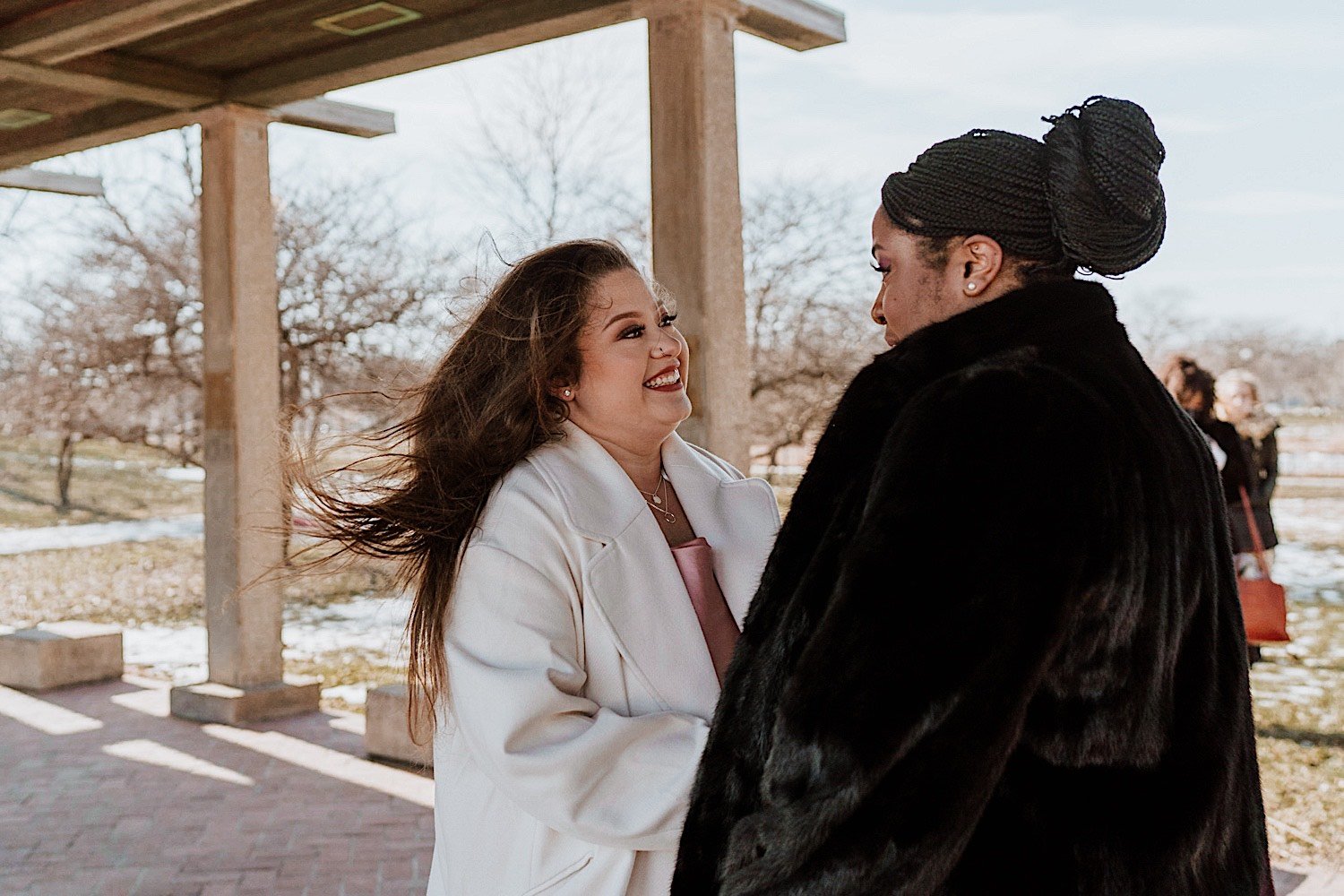 Brides smile with each other in Humboldt Park