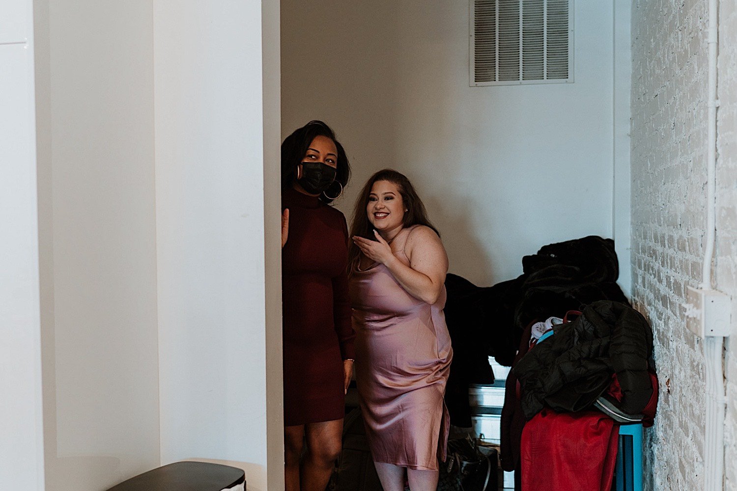 Brides stand next to one another laughing before entering their Humboldt Park wedding