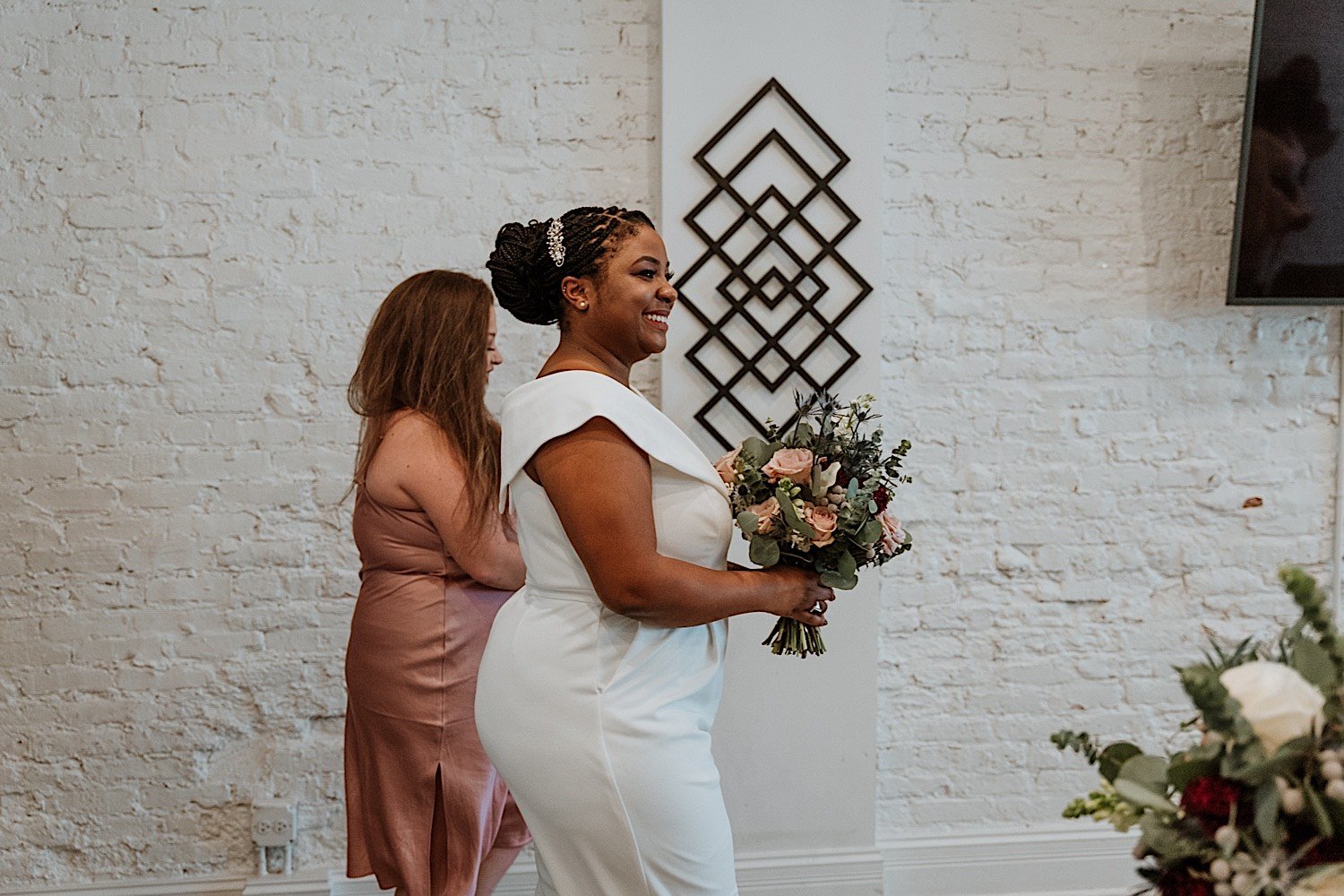 Brides walking down the aisle together of their Humboldt Park wedding holding flowers