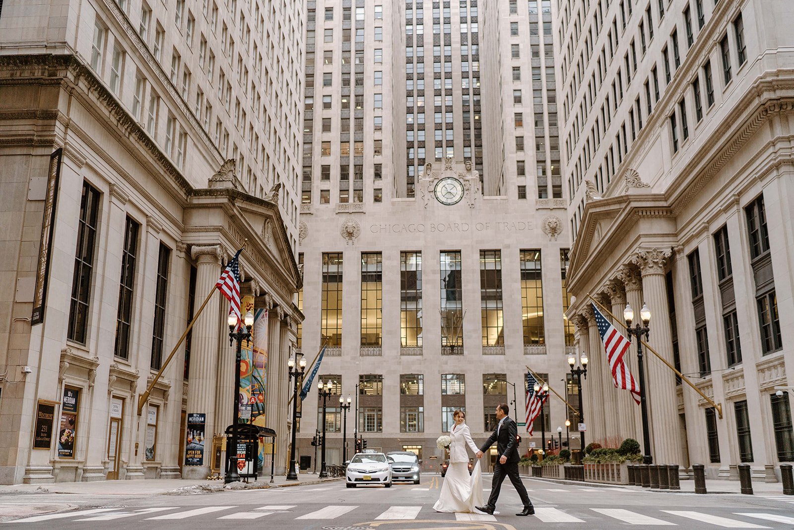 Bride and groom crossing a Chicago street after their elopement
