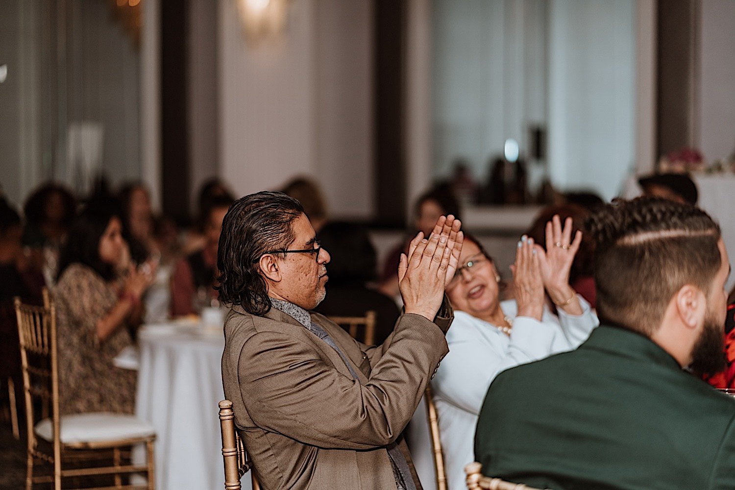 Wedding guests clap during first dance
