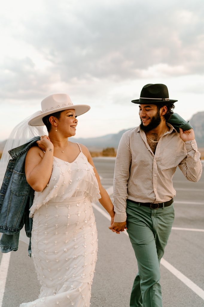 A bride and groom walking through a parking lot before their elopement in Las Vegas.