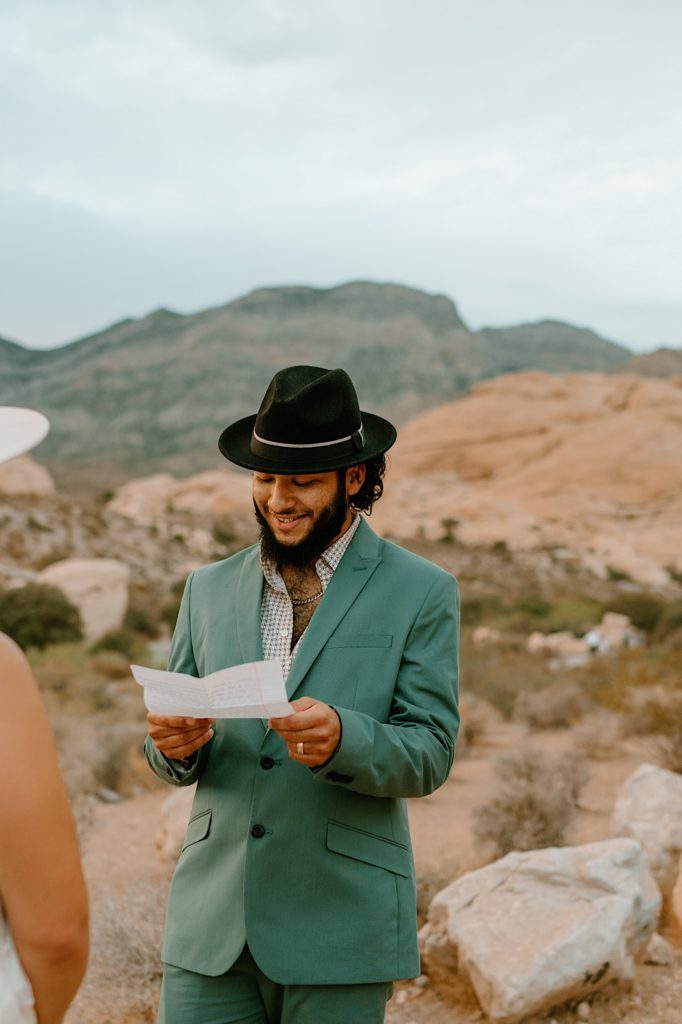 The bride and groom exchanged their vows privately surrounded by the red rocks in Las Vegas while the sun sets