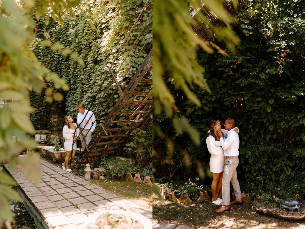 A couple walks up a metal stairwell in Chicago in front of a building covered in Ivy.