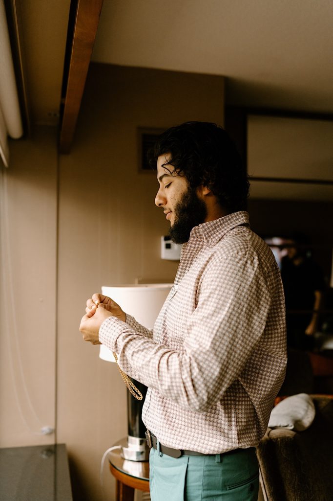 The groom gets ready for his Las Vegas elopement in his hotel room.