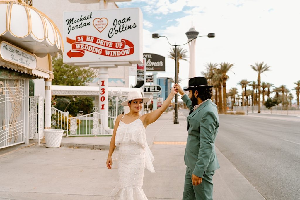 A bride and groom dance out in front of a chapel in Las Vegas before eloping.