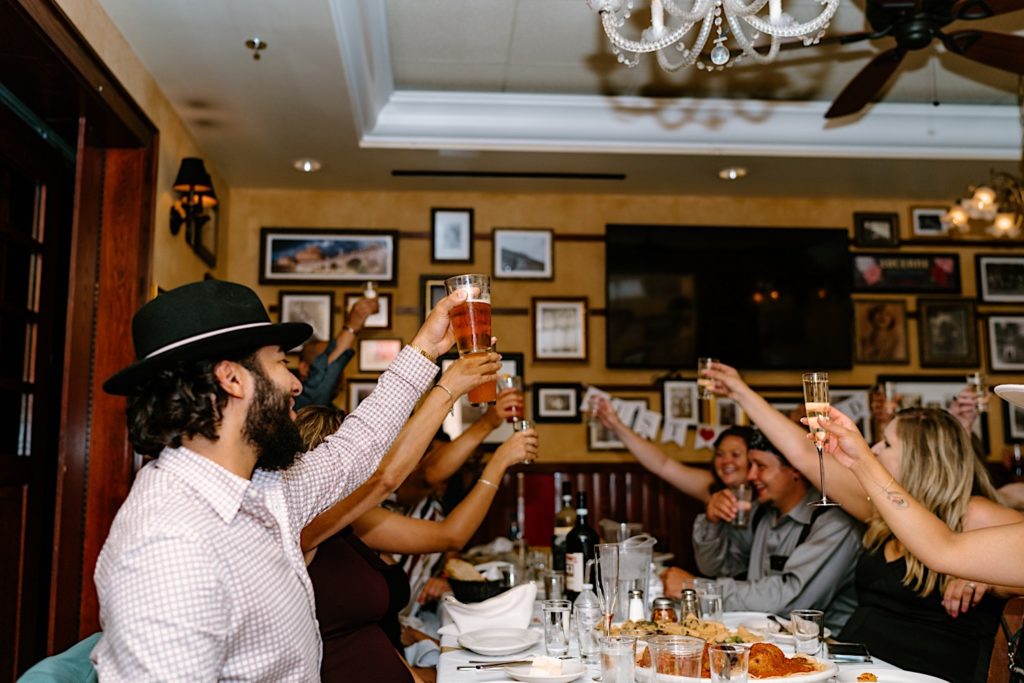 A toast is given at a restaurant wedding reception after eloping in Las Vegas Nevada.