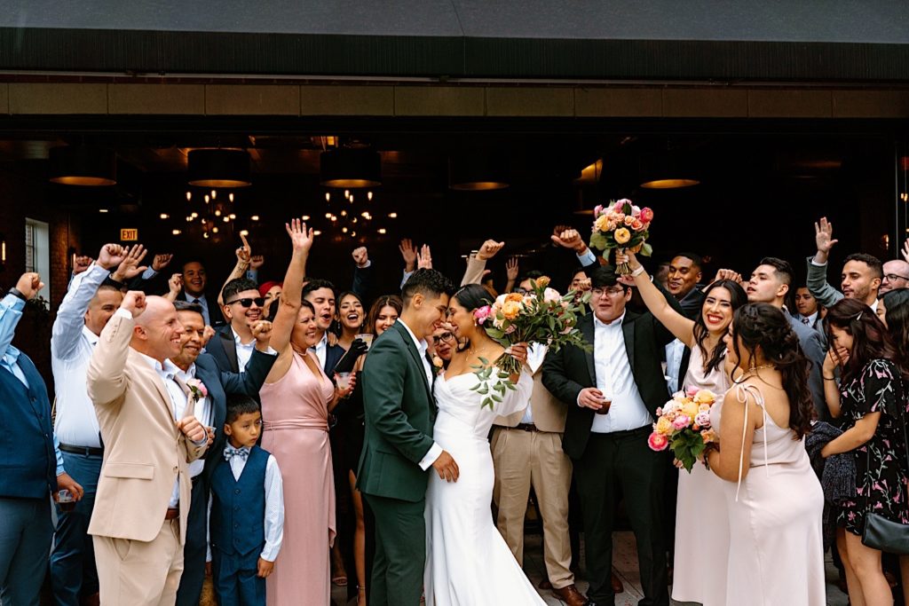 The bride and groom celebrate on a rooftop at Loft Lucia in Chicago.