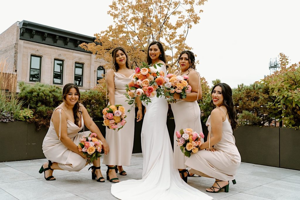 The bride and her wedding party posing for portraits on a Chicago rooftop.