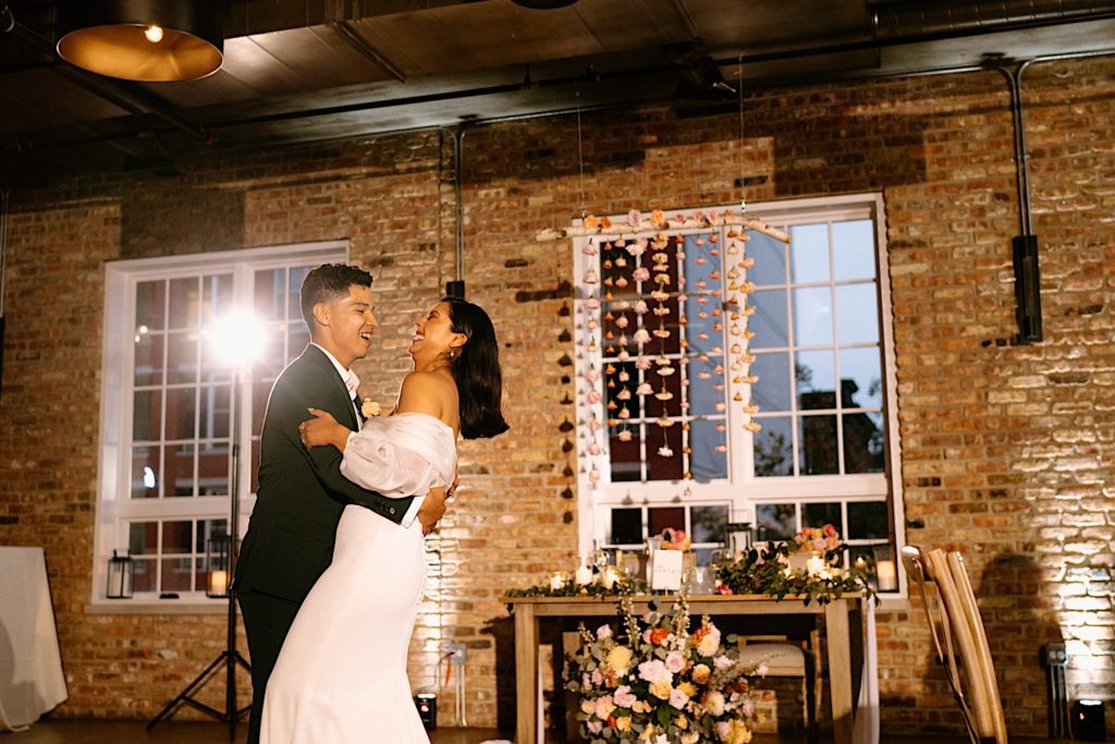 The bride and groom share their first dance on their wedding day at Loft Lucia.