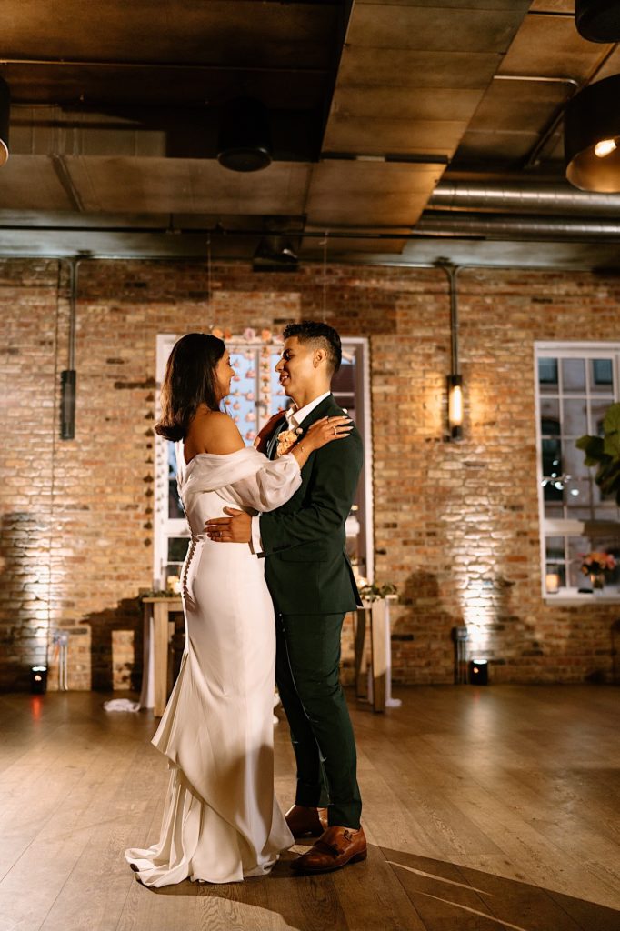 The bride and groom share their first dance on their wedding day at Loft Lucia.