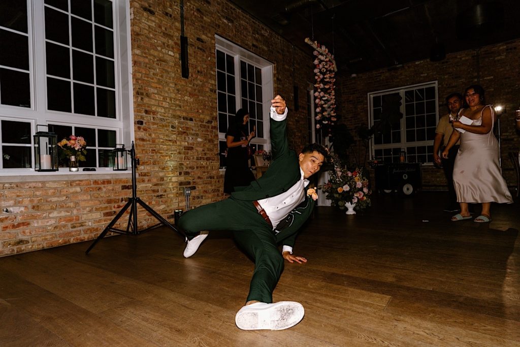 The groom dances hard celebrating his marriage on his wedding day.