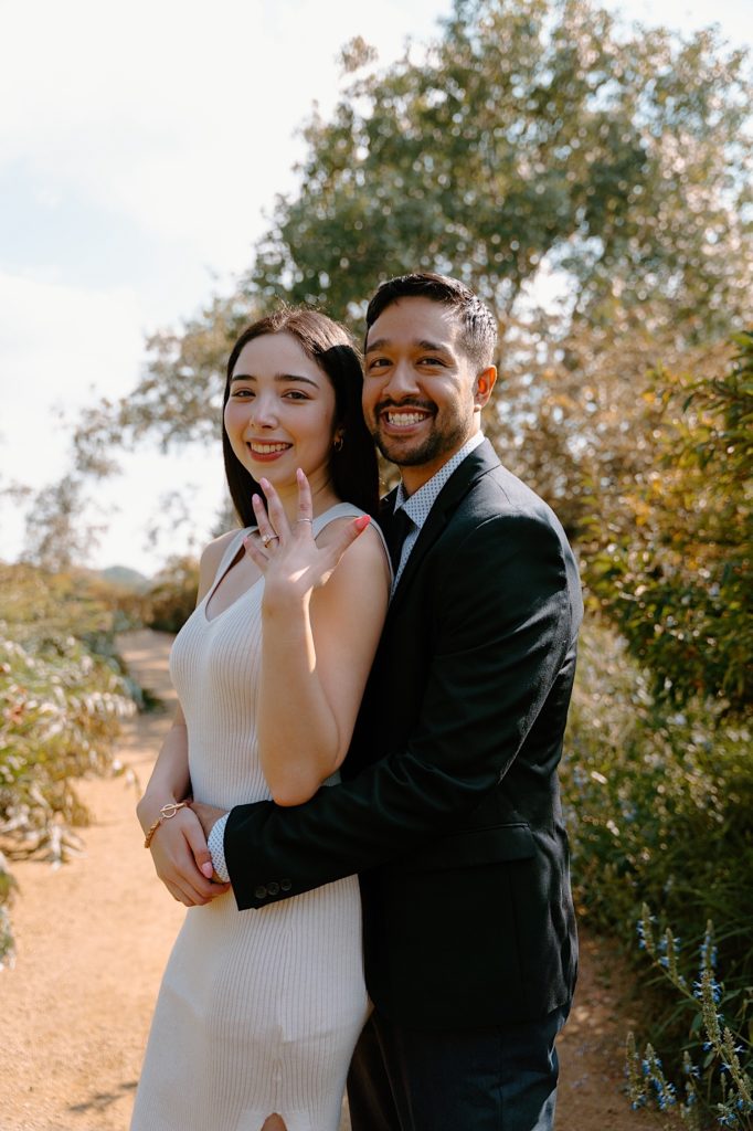 A fiancée shows off her brand new ring after their proposal at the Chicago Botanic Gardens.