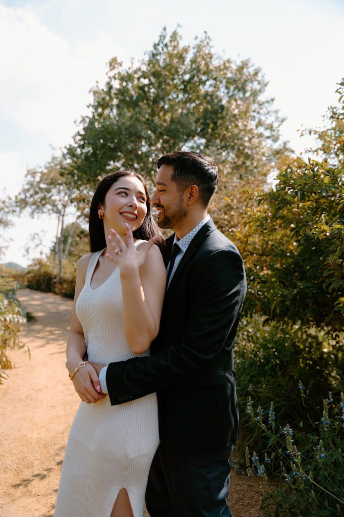 A fiancée shows off her brand new ring after their proposal at the Chicago Botanic Gardens.