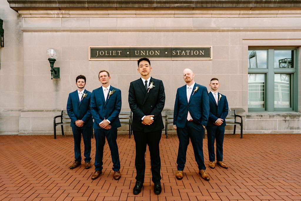 A groom stands with his bridal party prior to his wedding ceremony at Joliet Union Station.