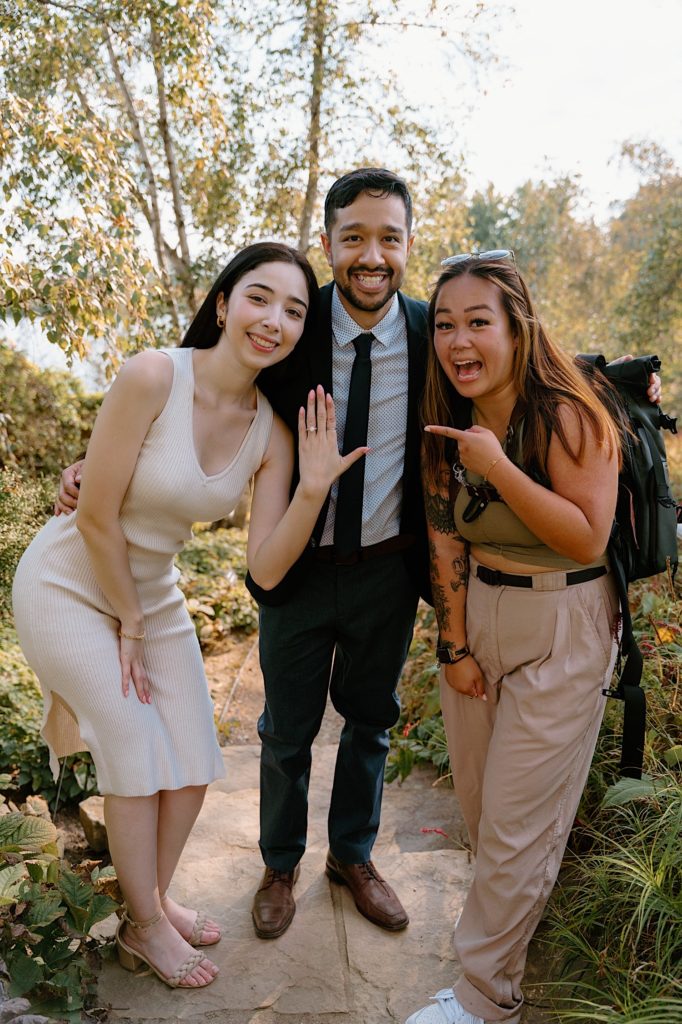 Kriztelle Halili stands with her engagement clients at the Chicago Botanic Gardens