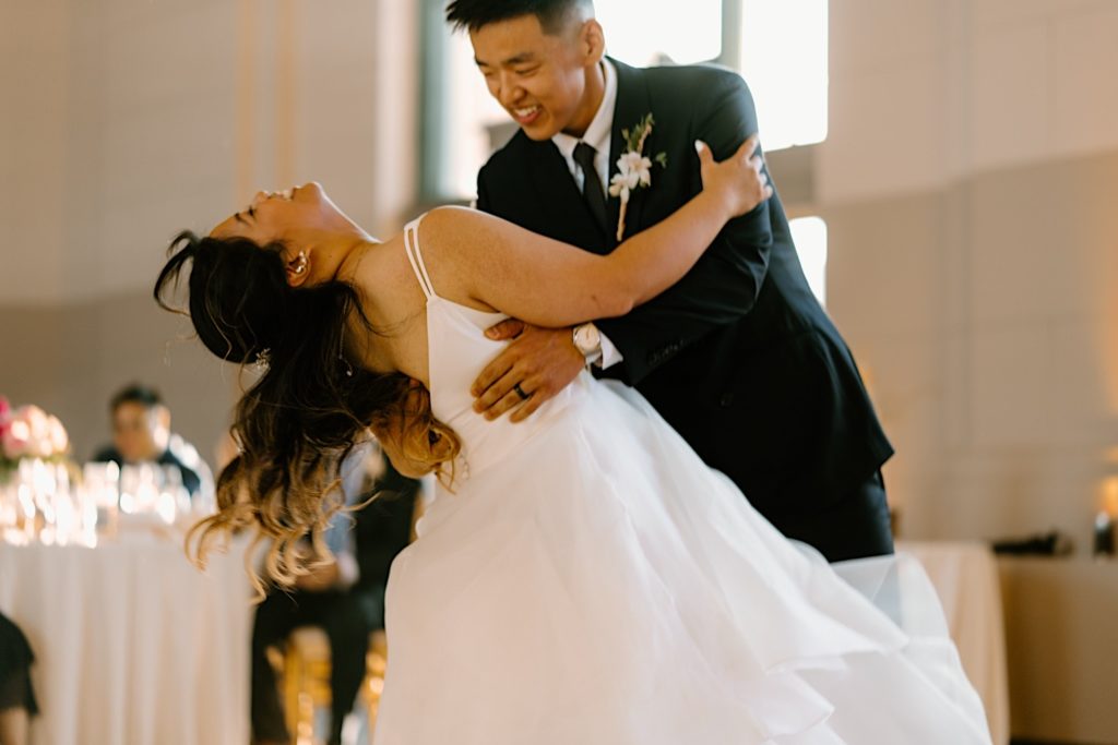 The bride and groom have their first dance at their wedding reception at Joliet Union Station celebrating with their guests.