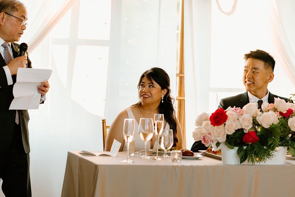 The father of the bride shares a toast with the guests of his daughters wedding.