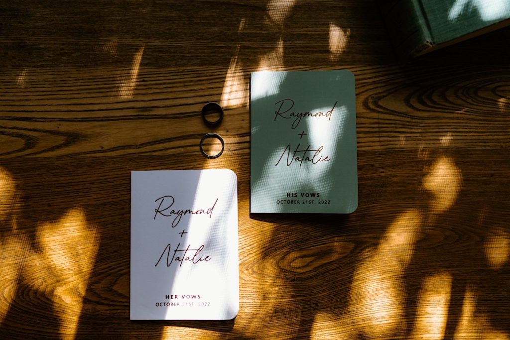 Custom vow books in green and white for the bride and groom.