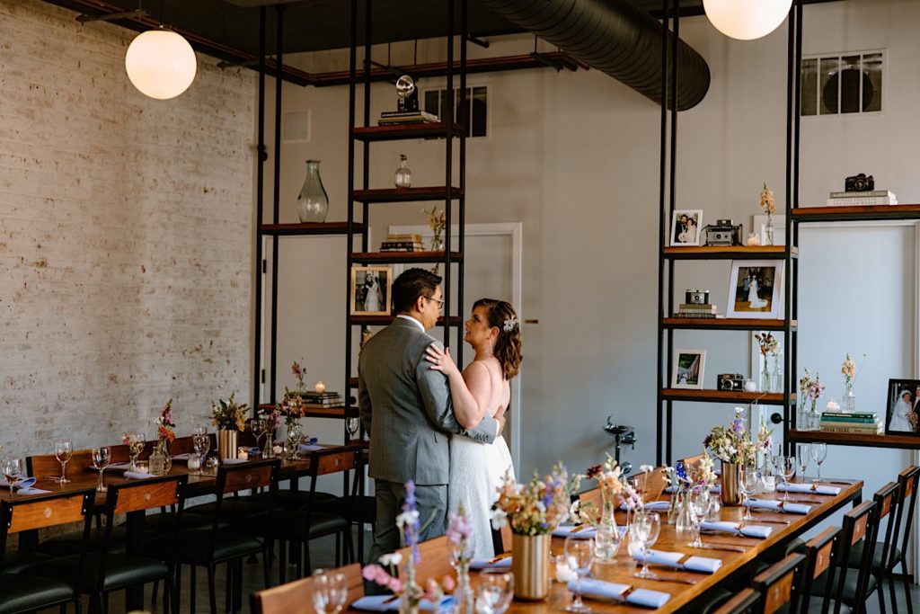 A bride and groom stand together at their intimate wedding at the Lytle House in Chicago.