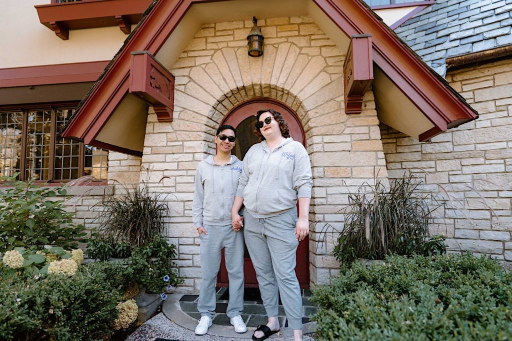 A bride and groom standing together outside of the Grove Redfield Estate.
