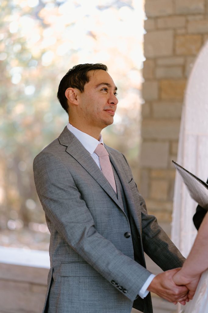 A bride and groom standing at their elopement ceremony at the Grove Redfield Estate.