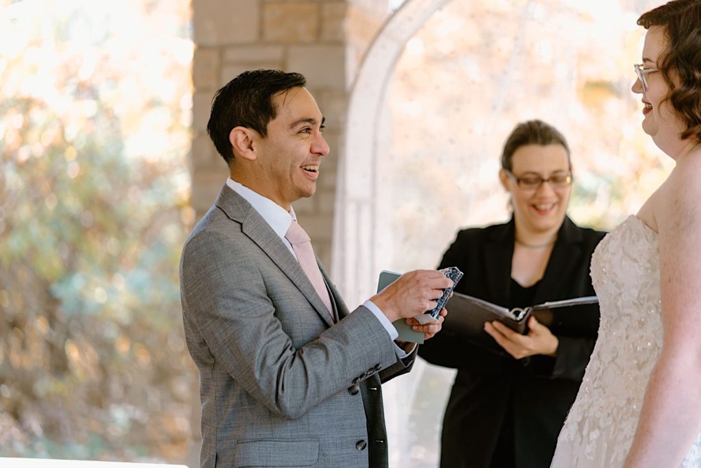 A bride and groom exchange vows at their elopement ceremony at the Grove Redfield Estate.