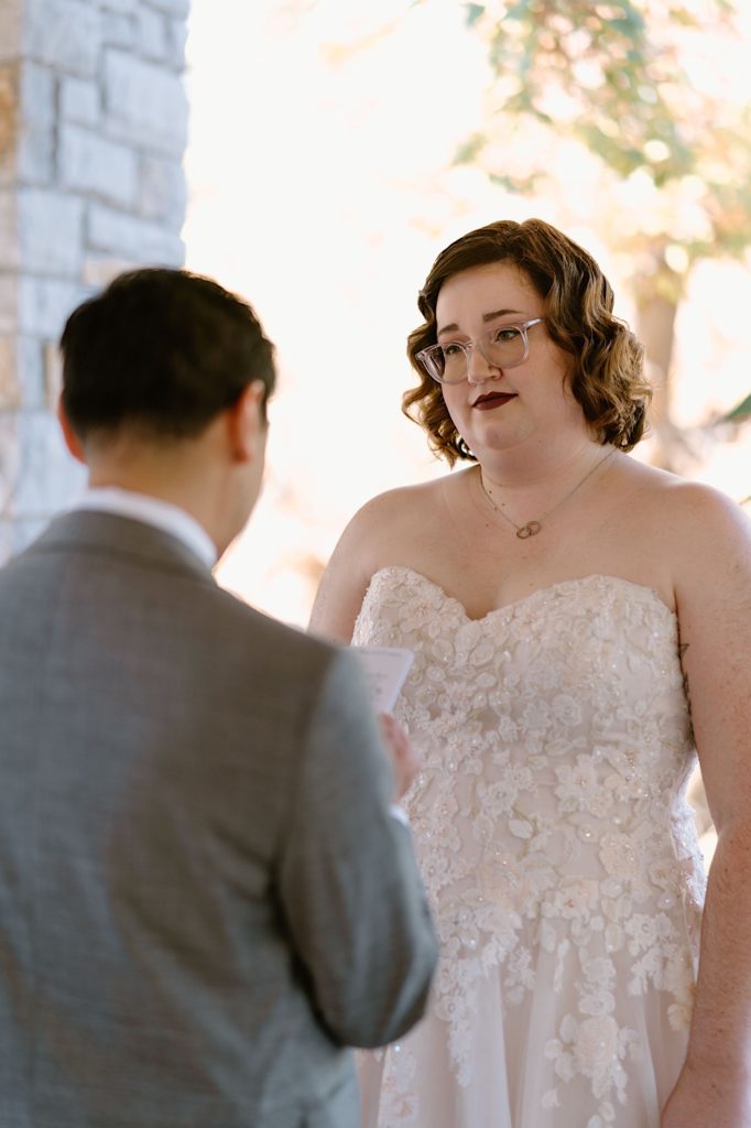 A bride and groom exchange vows at their elopement ceremony at the Grove Redfield Estate.