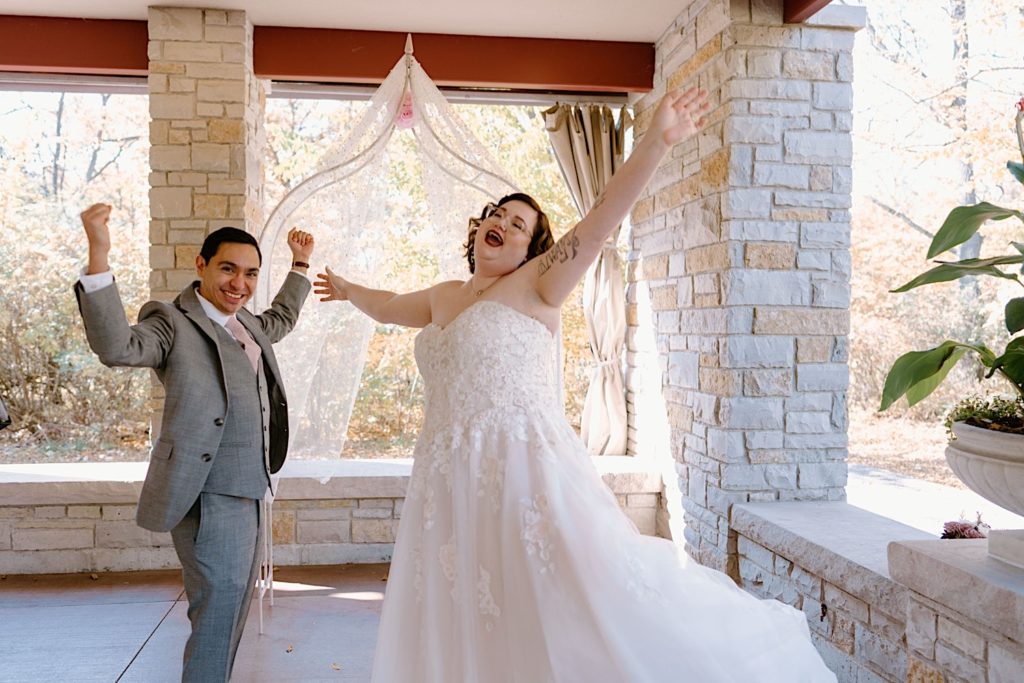 A bride and groom celebrate after their elopement ceremony at the Grove Redfield Estate.