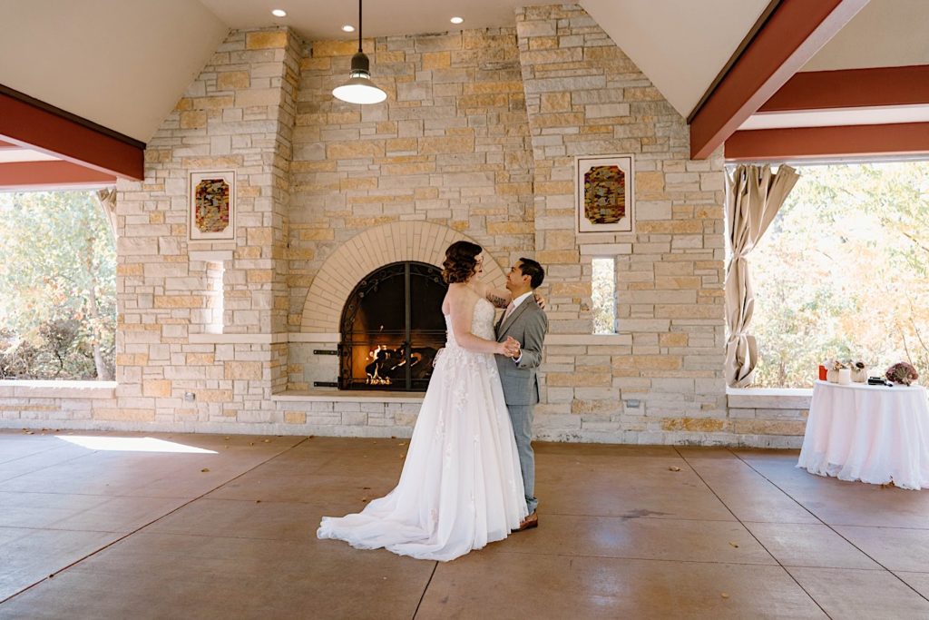 A bride and groom share their first dance under the pavilion at the Grove Redfield Estate