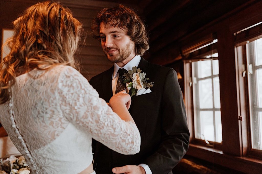 A groom looks lovingly at his bride during their first look at their elopement at Starved Rock State Park.