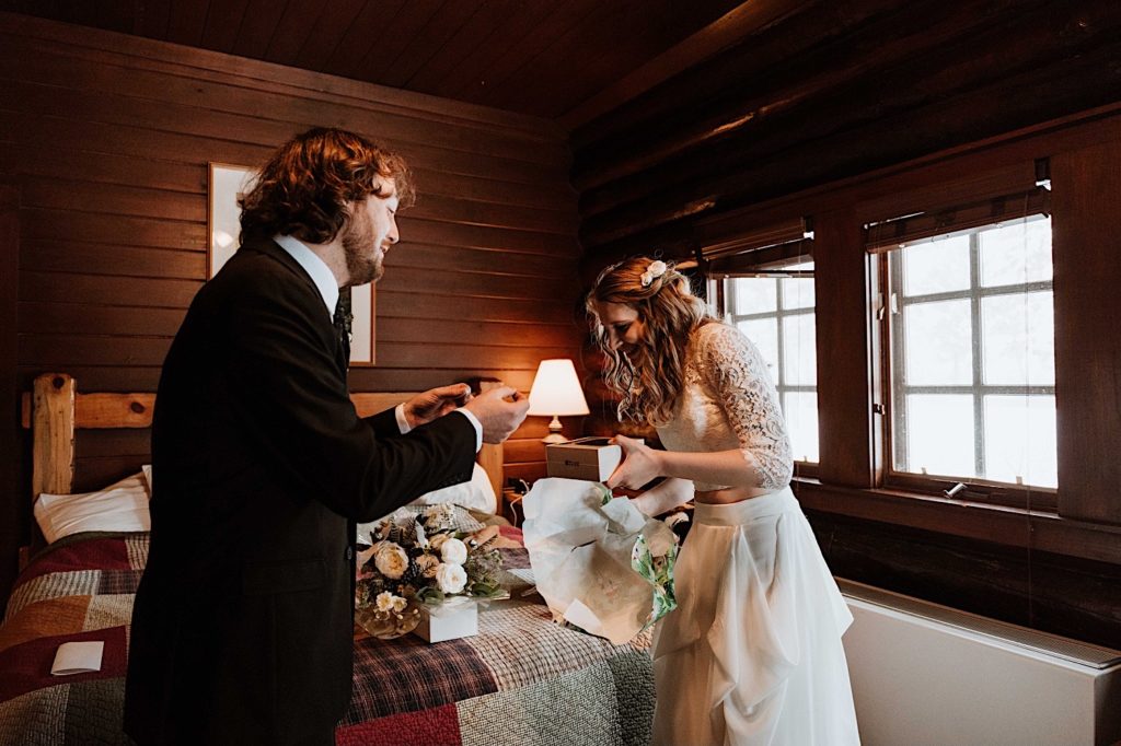 A bride and groom open gifts they gave one another the morning of their elopement in Central Illinois
