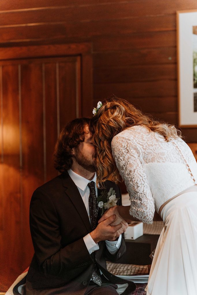 A bride and groom sit reading letters to one another while reading letters from family and friends before they elope at Starved Rock National Park
