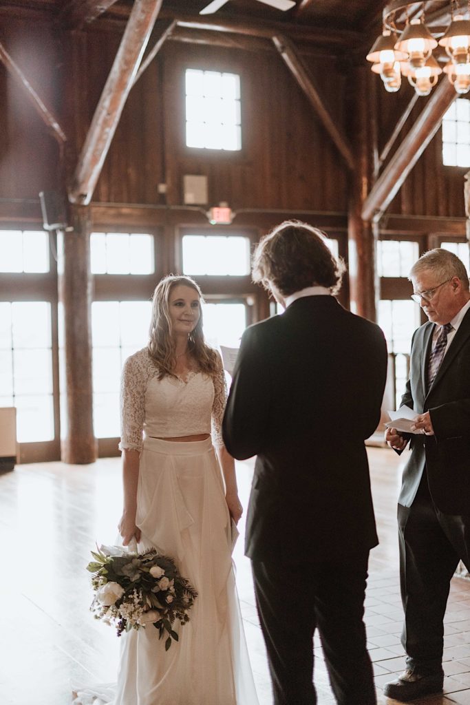 A bride and groom stand during their wedding ceremony at a cabin in Starved Rock National Park.