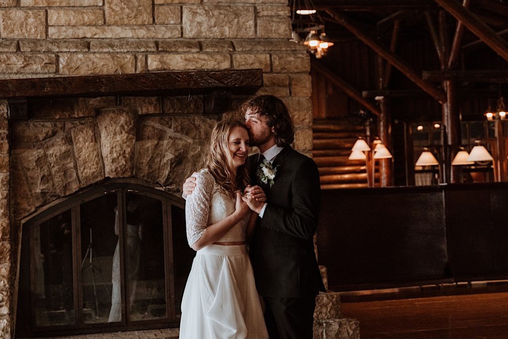 A bride and groom kiss during their wedding ceremony at a cabin in Starved Rock National Park