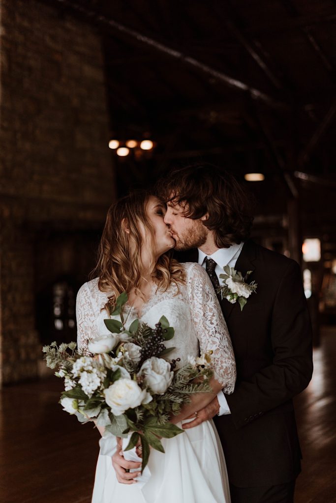 A bride and groom kiss after their wedding ceremony at a cabin in Starved rock National Park