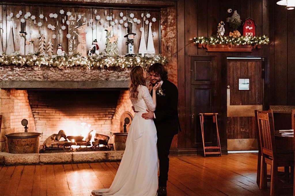 A bride and groom share a first dance in front of the fireplace after taking their wedding portraits at Starved Rock National Park.
